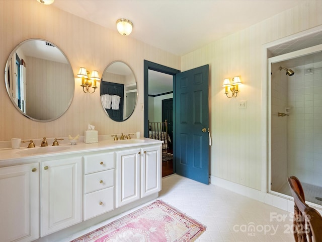 full bathroom with wallpapered walls, a stall shower, double vanity, and baseboards