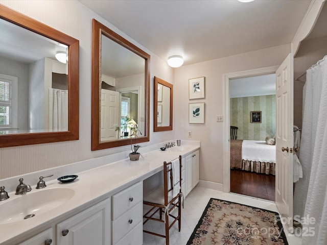 full bath with double vanity and connected bathroom