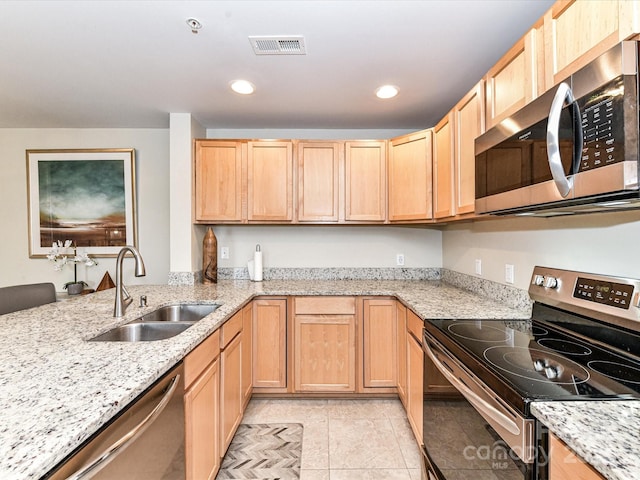 kitchen with visible vents, light brown cabinets, a sink, light tile patterned floors, and stainless steel appliances