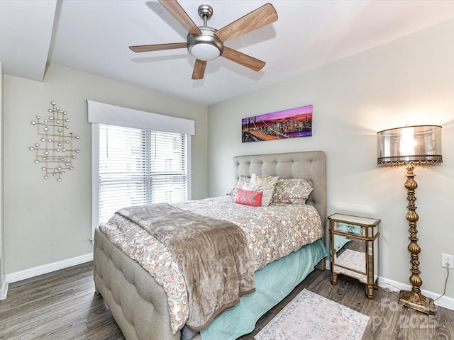 bedroom featuring baseboards, ceiling fan, and wood finished floors