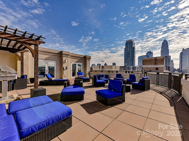view of patio / terrace with a pergola, an outdoor living space, and a view of city