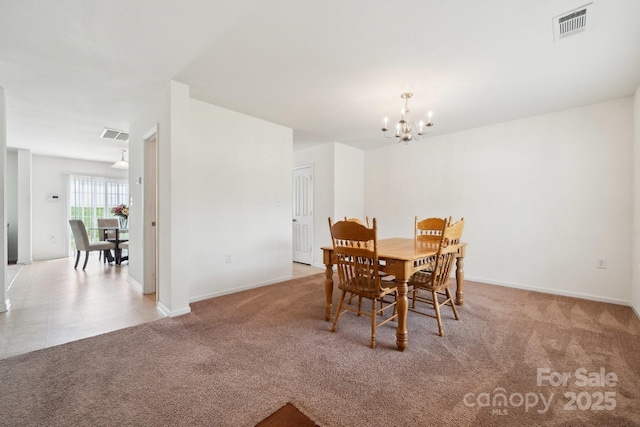 carpeted dining area with baseboards, a chandelier, and visible vents