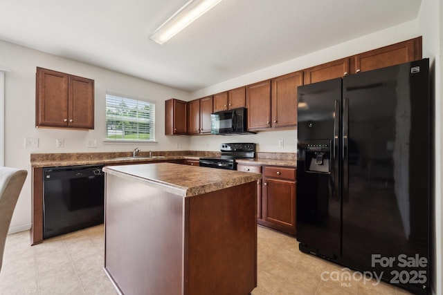kitchen with a sink, a center island, black appliances, and light tile patterned flooring