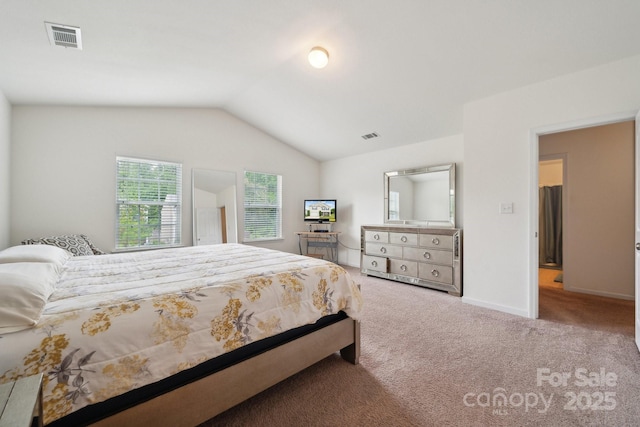 carpeted bedroom featuring baseboards, visible vents, and vaulted ceiling