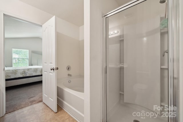 bathroom with tile patterned flooring, ensuite bath, and a stall shower