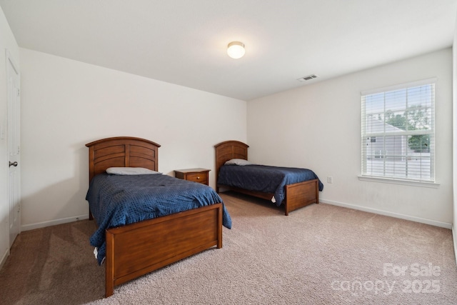 carpeted bedroom featuring visible vents and baseboards
