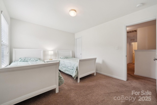 bedroom with carpet flooring, baseboards, and visible vents