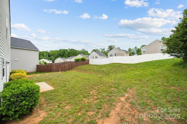 view of yard featuring fence and a residential view