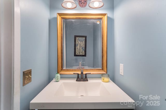 bathroom with vanity and a chandelier