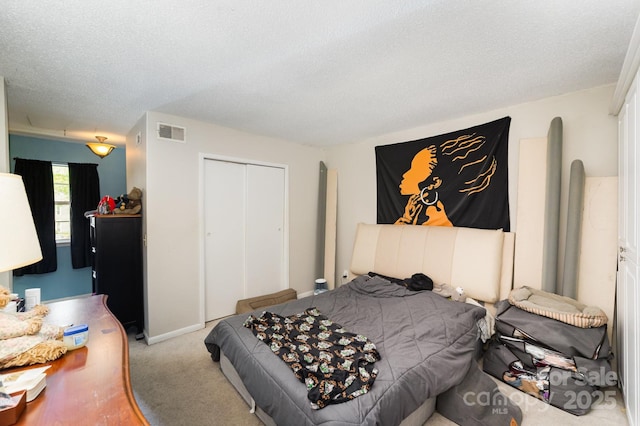 carpeted bedroom featuring a closet and a textured ceiling