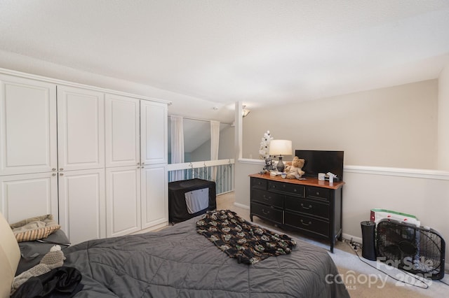 bedroom featuring light carpet, a closet, and baseboards