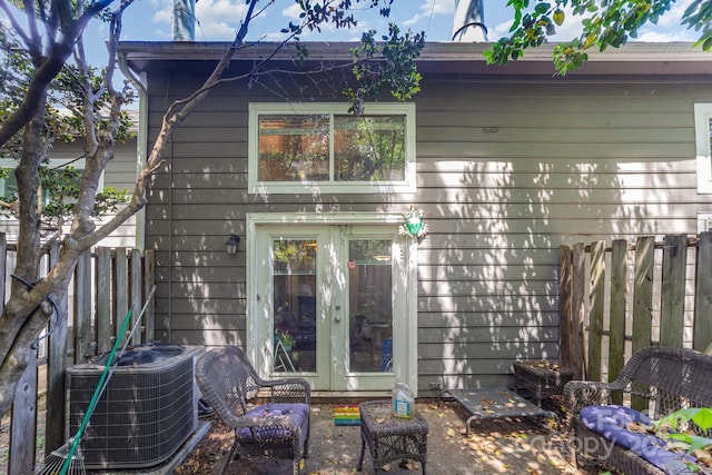 back of house with french doors, fence, and central AC unit