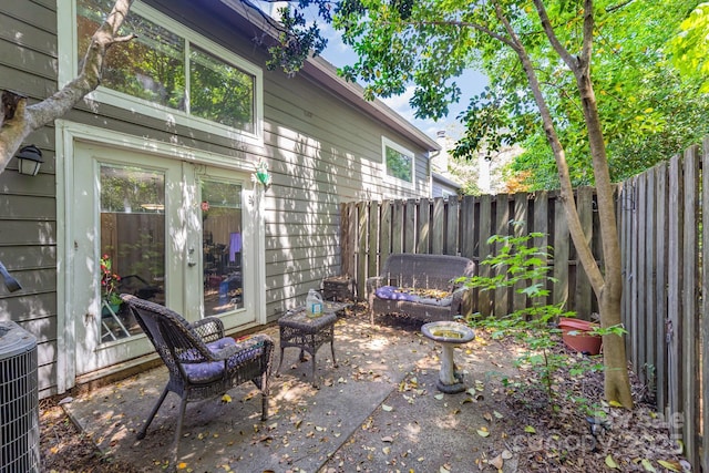 view of patio with a fenced backyard and central AC unit