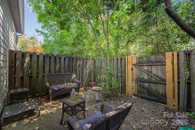 view of patio / terrace featuring a fenced backyard and a gate