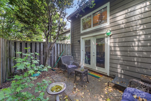 view of patio / terrace featuring fence and french doors