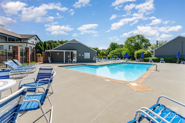 community pool featuring fence and a patio