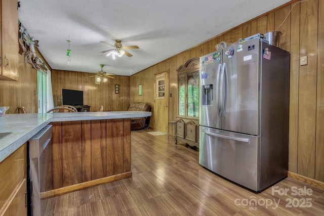 676 Arrowhead Trl Unit 6, Marion, NC 28752 - kitchen featuring stainless steel appliances, brown cabinets, wood walls, a ceiling fan, and wood finished floors