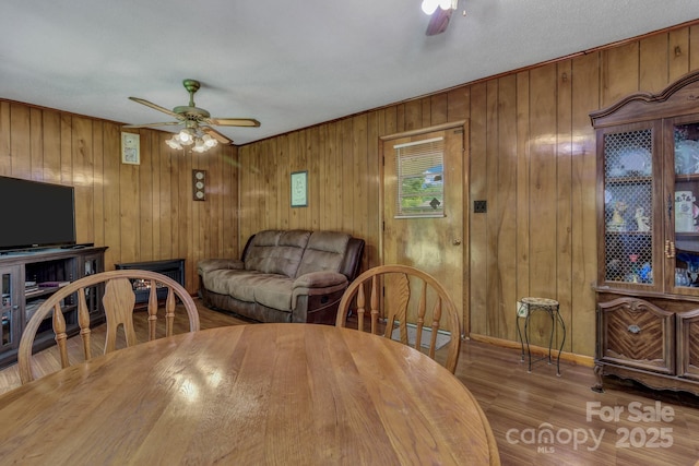 676 Arrowhead Trl Unit 6, Marion, NC 28752 - dining area featuring ceiling fan, wood walls, wood finished floors, and baseboards