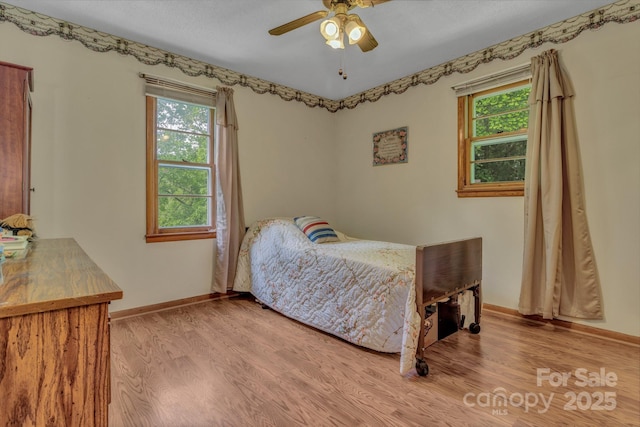 676 Arrowhead Trl Unit 6, Marion, NC 28752 - bedroom with multiple windows, wood finished floors, baseboards, and a ceiling fan