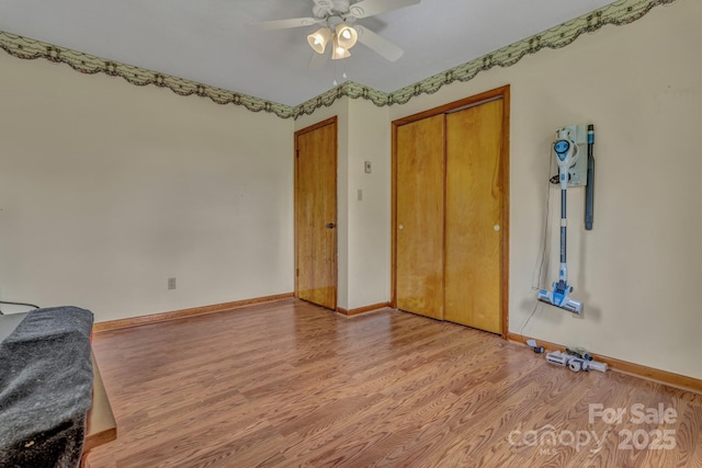 676 Arrowhead Trl Unit 6, Marion, NC 28752 - unfurnished bedroom with wood finished floors, baseboards, a closet, and a ceiling fan