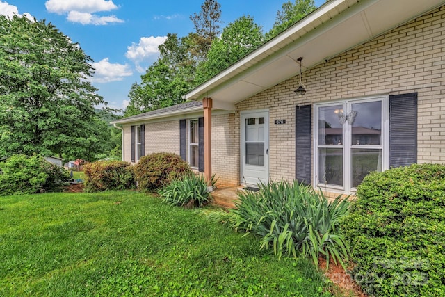 676 Arrowhead Trl Unit 6, Marion, NC 28752 - view of home's exterior with brick siding and a yard