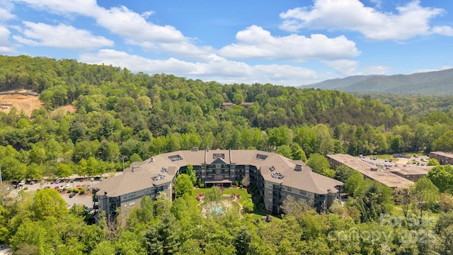 drone / aerial view featuring a forest view
