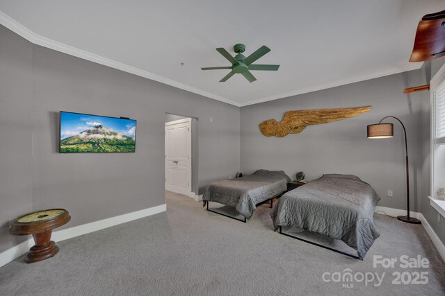 bedroom with crown molding, a ceiling fan, carpet flooring, and baseboards