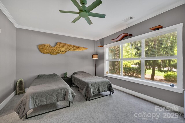 bedroom featuring visible vents, ornamental molding, carpet flooring, baseboards, and a ceiling fan