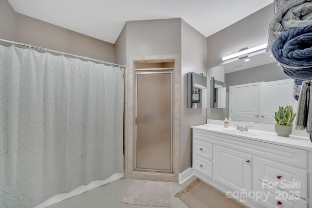 full bath featuring tile patterned floors, a shower with shower curtain, and vanity