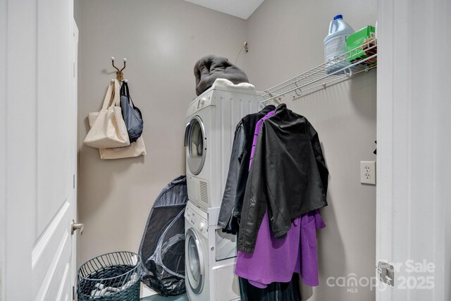 laundry room featuring stacked washing maching and dryer and laundry area