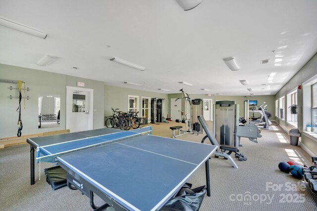 recreation room featuring carpet flooring and visible vents