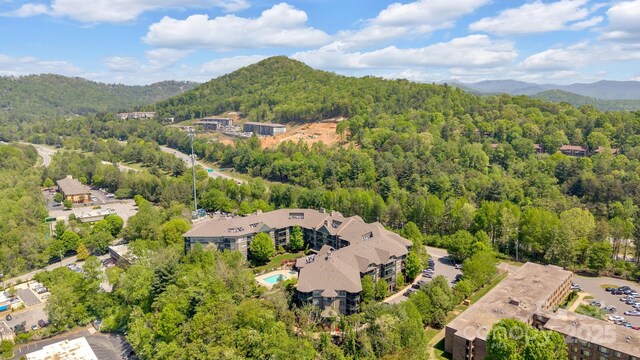 aerial view featuring a view of trees and a mountain view