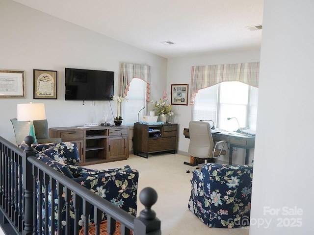 carpeted living area featuring visible vents