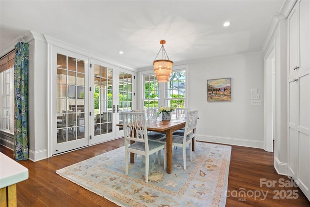 dining room featuring a chandelier, baseboards, dark wood finished floors, recessed lighting, and crown molding