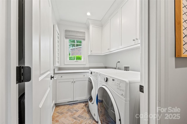 washroom featuring cabinet space, washer and dryer, crown molding, brick patterned flooring, and recessed lighting