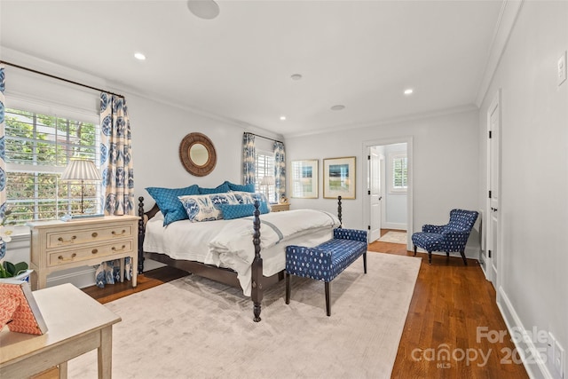 bedroom with ornamental molding, wood finished floors, recessed lighting, and baseboards