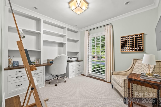 home office featuring built in desk and ornamental molding