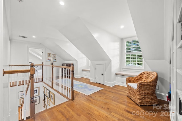 additional living space with wood finished floors, lofted ceiling, baseboards, and recessed lighting