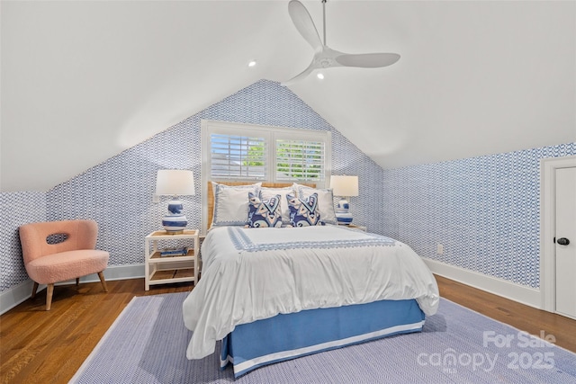 bedroom with wallpapered walls, wood finished floors, ceiling fan, baseboards, and vaulted ceiling