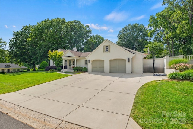 view of front of house featuring driveway, a garage, a chimney, and stucco siding