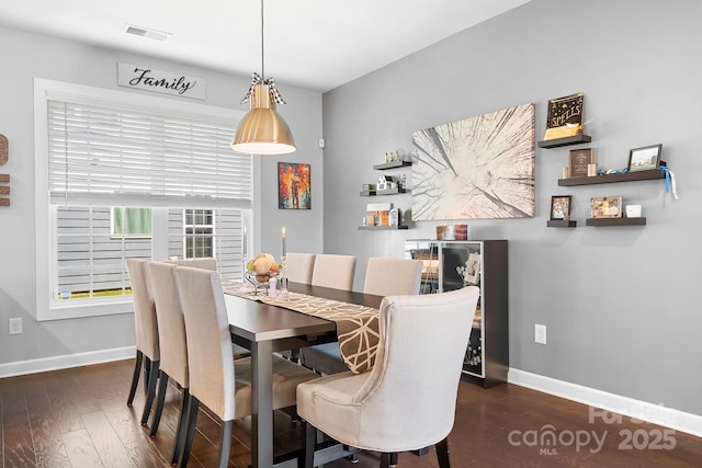 dining room featuring baseboards and wood finished floors