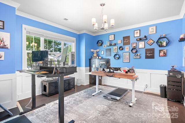 office space featuring a chandelier, wainscoting, a decorative wall, and wood finished floors
