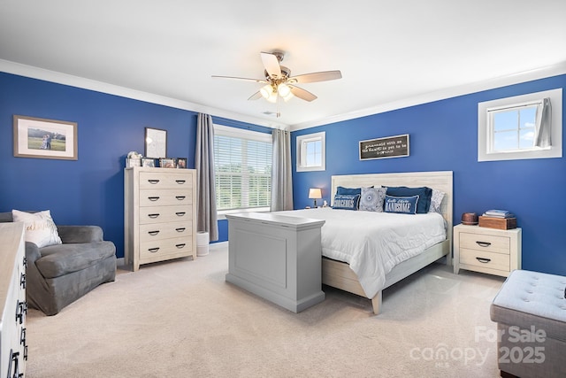 bedroom with light colored carpet, crown molding, and a ceiling fan
