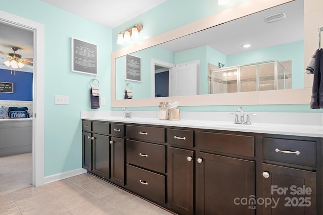 full bathroom featuring a shower stall, double vanity, ceiling fan, tile patterned floors, and baseboards