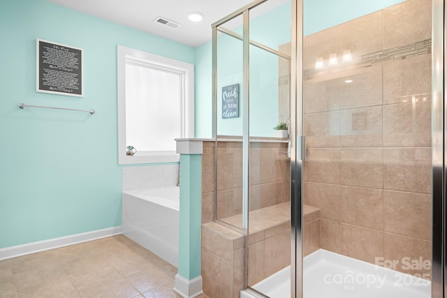 bathroom featuring a stall shower, baseboards, and a garden tub