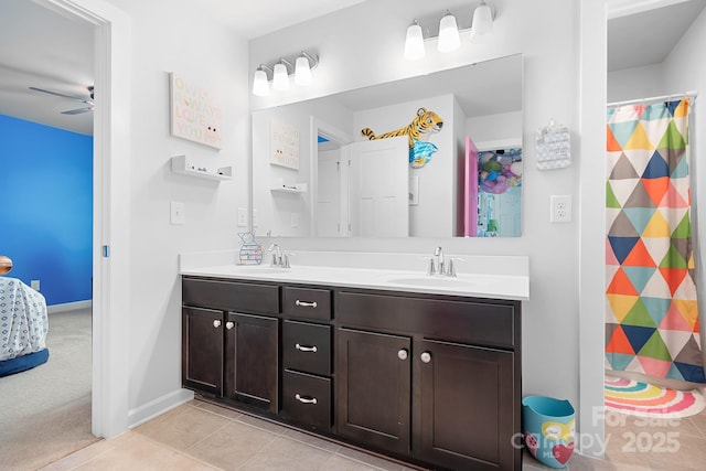full bathroom with double vanity, ceiling fan, tile patterned floors, curtained shower, and baseboards