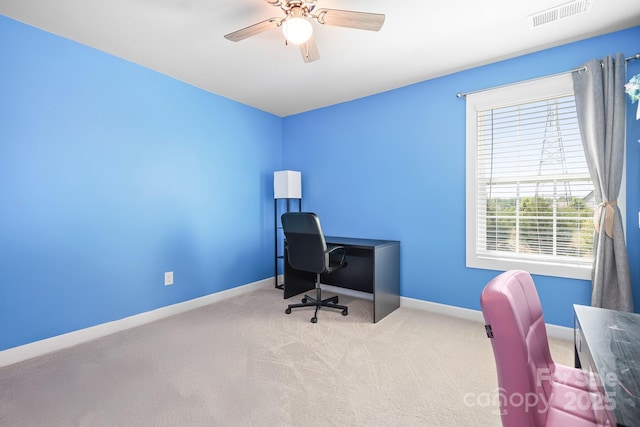 carpeted office with baseboards and ceiling fan