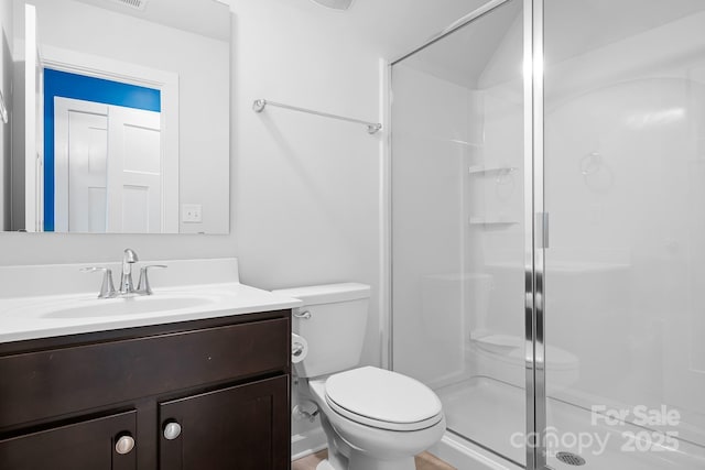 full bath featuring a shower stall, toilet, and vanity