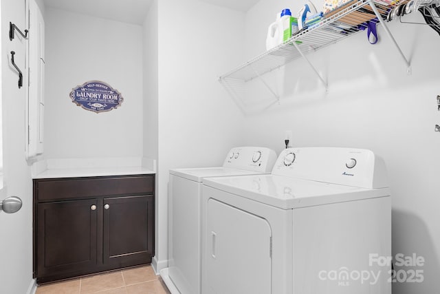 clothes washing area featuring washer and clothes dryer, cabinet space, light tile patterned flooring, and baseboards