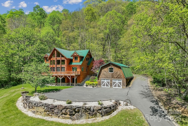 1104 Long Branch Rd, Mars Hill, NC 28754 - view of front of property with an outbuilding, a garage, a wooded view, a front yard, and driveway